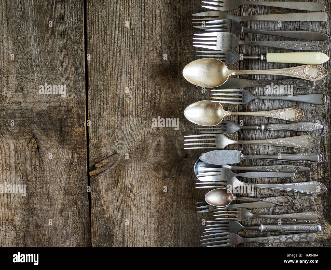 old cutlery on wooden weathering table Stock Photo