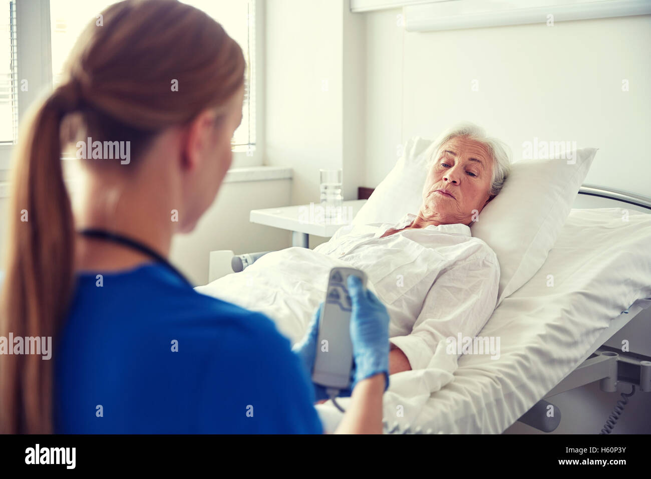doctor or nurse visiting senior woman at hospital Stock Photo - Alamy