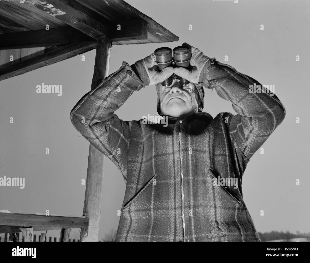 Man Looking Through Binoculars, Airplane Observation Post, Bantam, Connecticut, USA, Howard R. Hollem for Office of Emergency Management, January 1942 Stock Photo