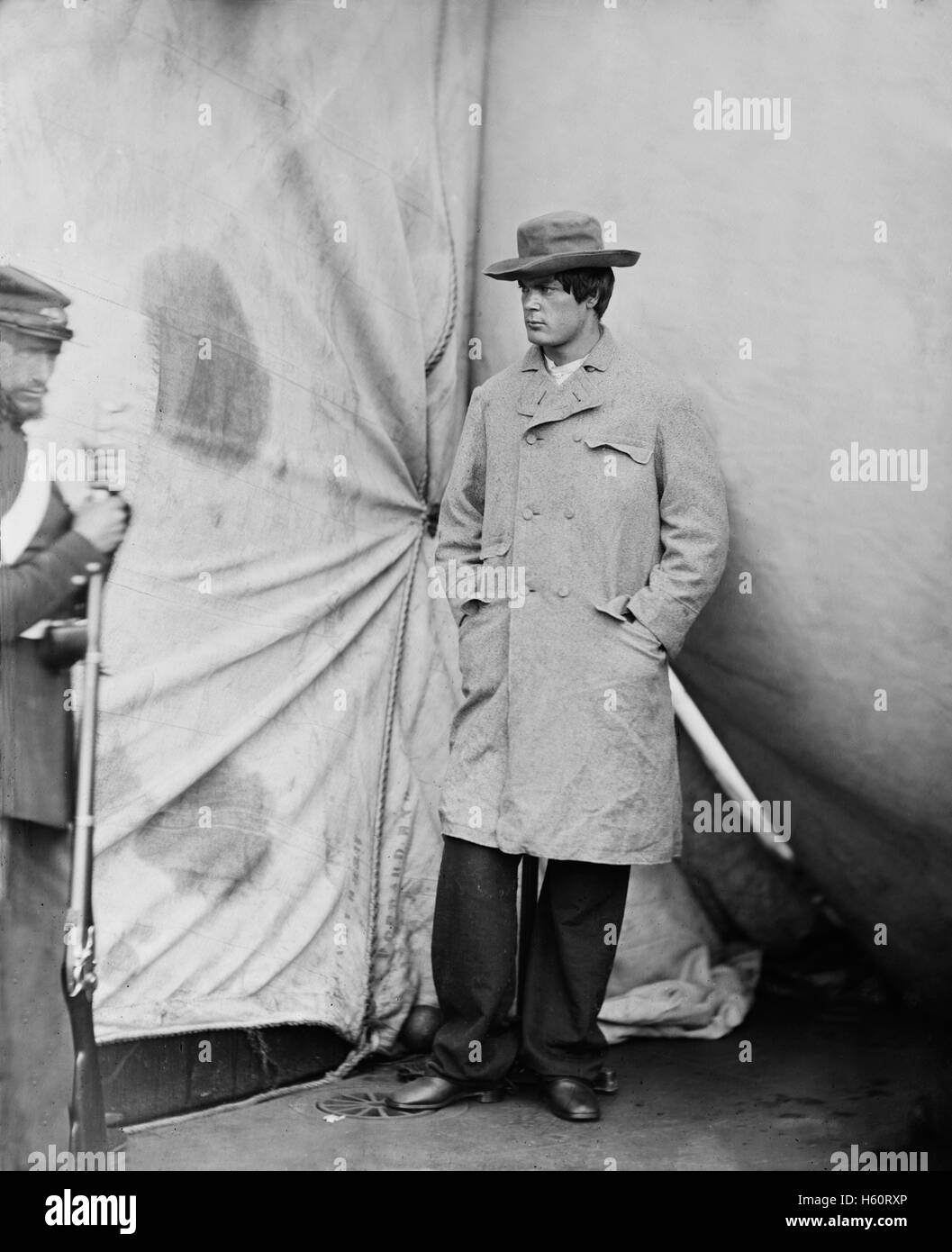 Lewis Powell, also known as Lewis Payne, Attacker of U.S. Secretary of State William H. Seward, and Conspirator in Assassination of U.S. President Abraham Lincoln, Standing in Overcoat with Hat, Washington Navy Yard, Washington DC, USA, by Alexander Gardner, April 1865 Stock Photo
