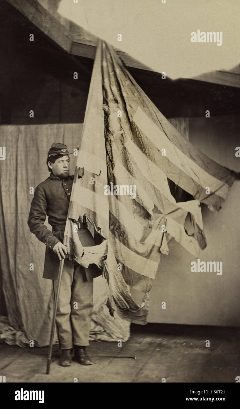 Unidentified Union Soldier Holding Tattered Flag of 37th Pennsylvania Infantry during American Civil War, USA, 1861 Stock Photo