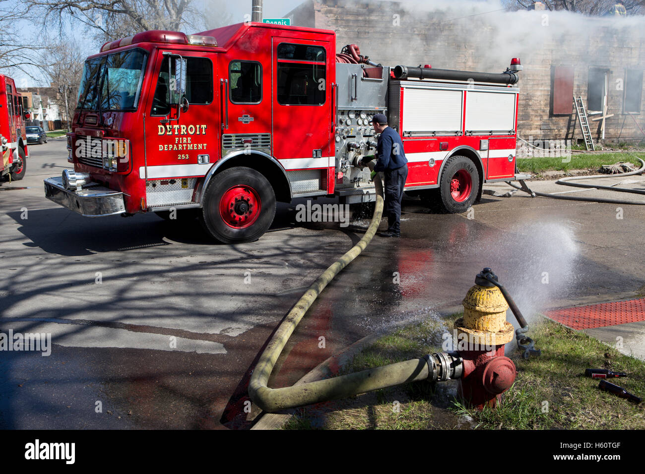 Fire engine pumper hooked to fire hydrant at house fire, Detroit Stock