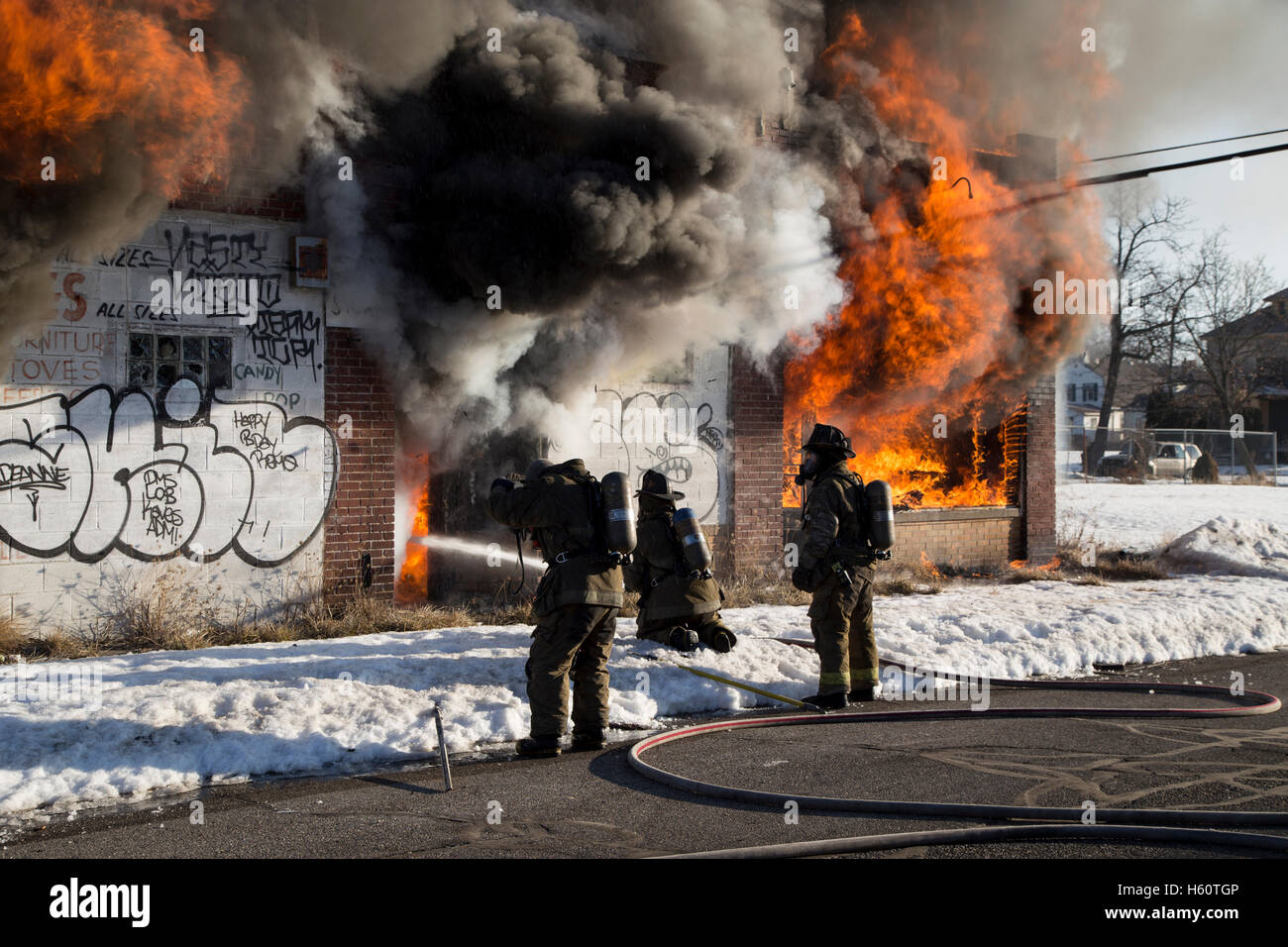 Firefighters extinguishing fire in vacant commercial building, Detroit, Michigan USA Stock Photo