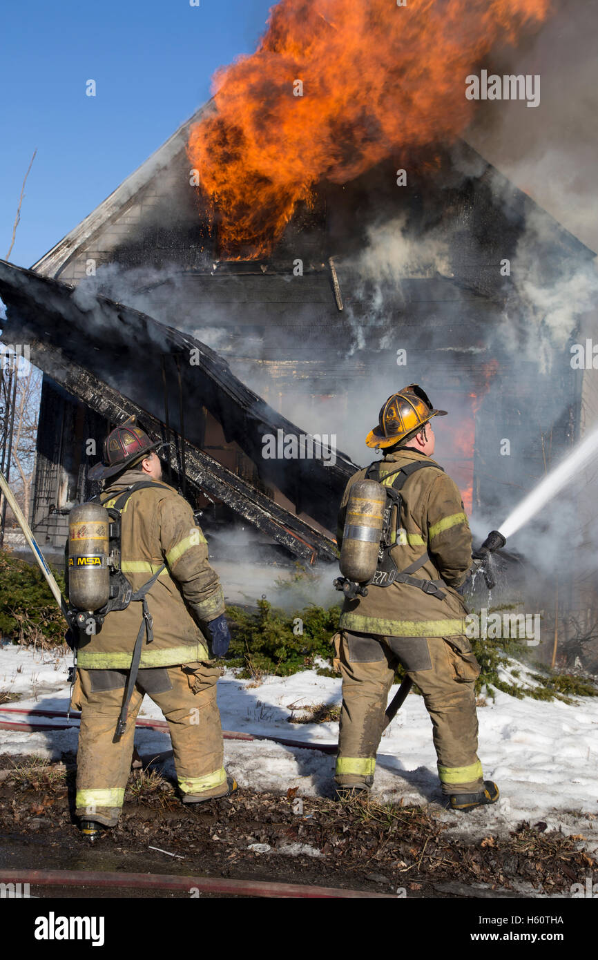 Firefighters extinguishing house fire, Detroit, Michigan USA Stock Photo