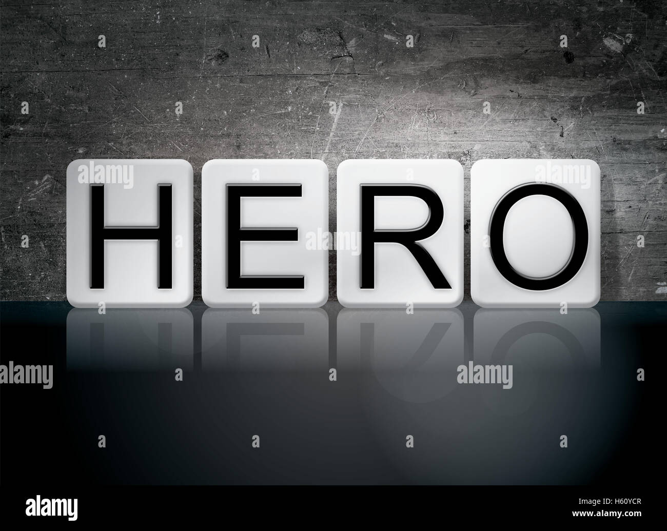 The word 'Hero' written in white tiles against a dark vintage grunge background. Stock Photo