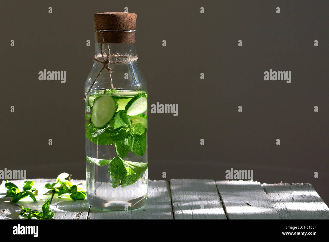 Nutritious detox water or emonade with cucumber and mint on wooden table. Copy space for text. Stock Photo