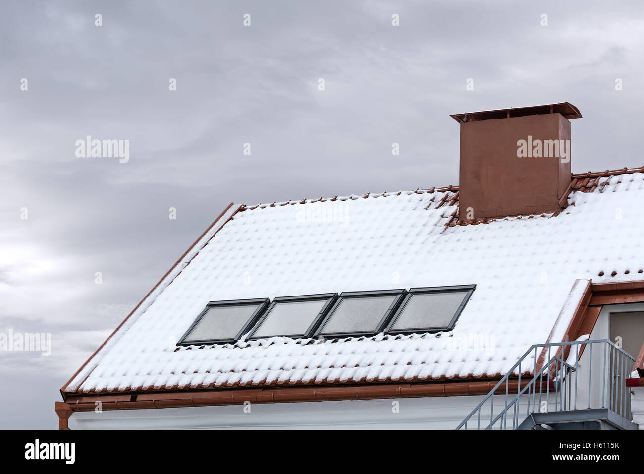 skylight and red chimney on snow covered roof Stock Photo Alamy