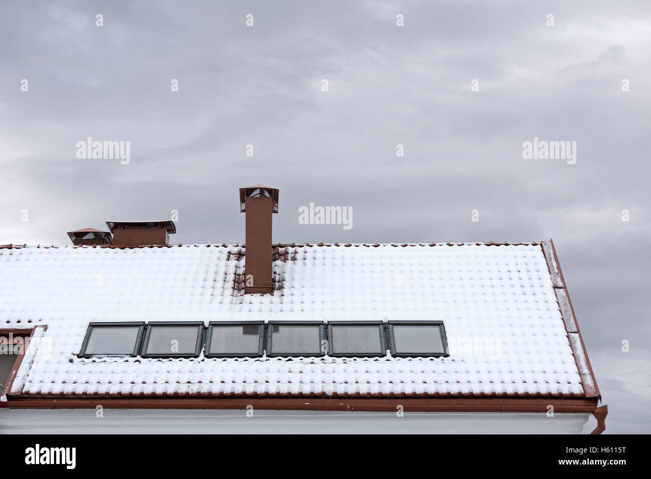 snow covered roof with skylights and chimney Stock Photo Alamy