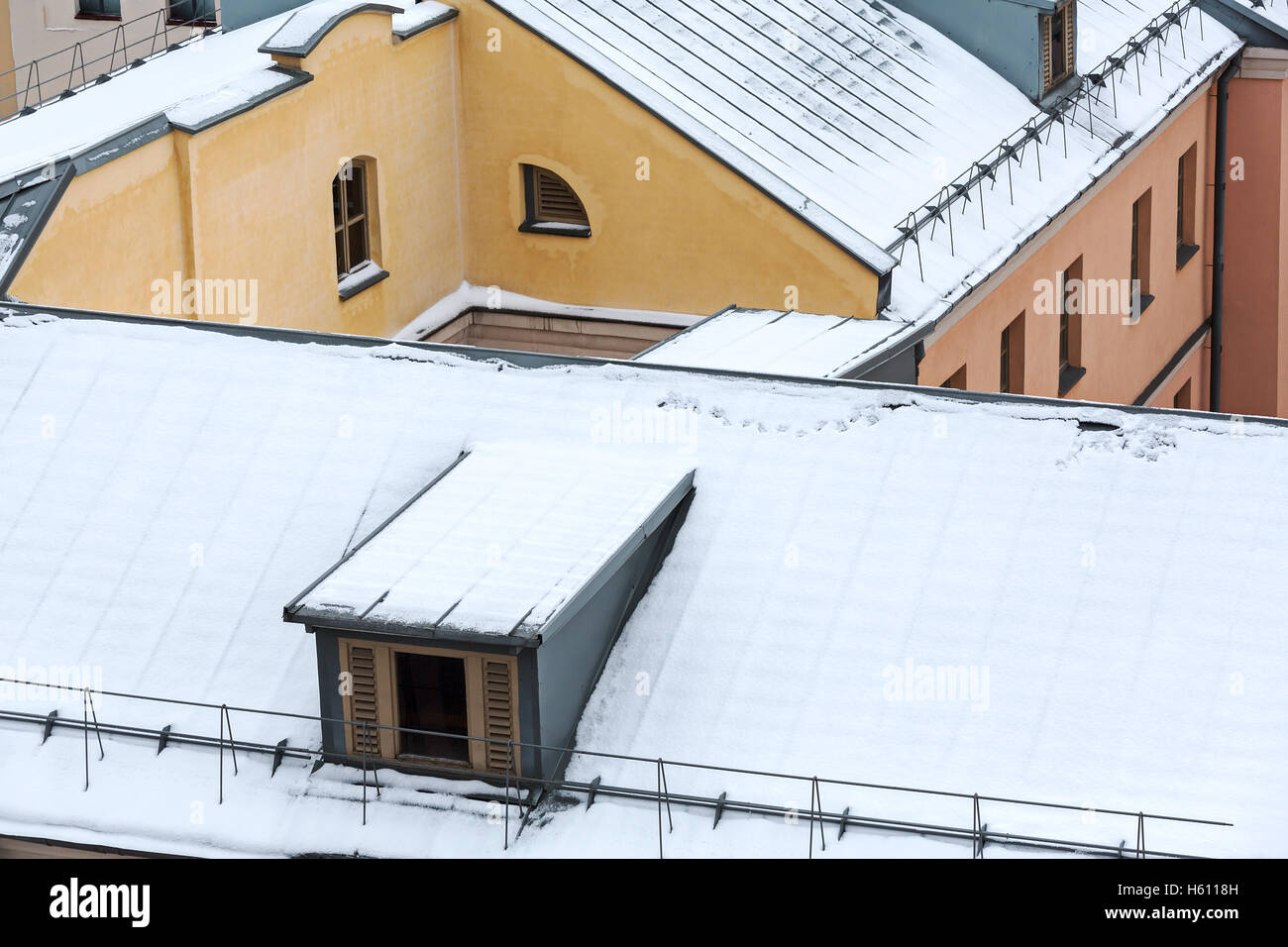 Snowy Roof Of Residential Houses With Gable Dormers Stock Photo