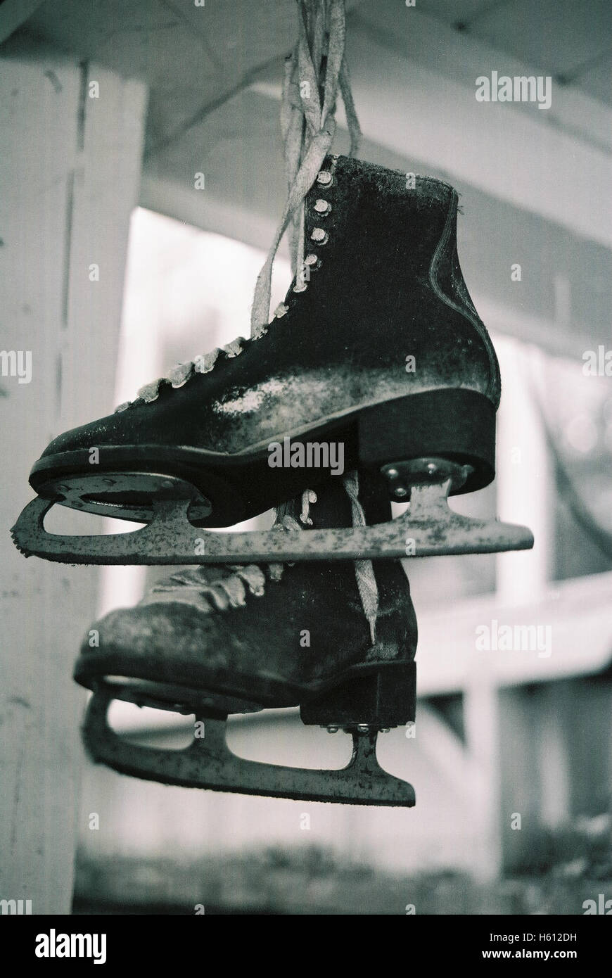 A pair of old vintage ice skates left hanging up in a porch in Hope New Jersey photographed with a black and white film Stock Photo