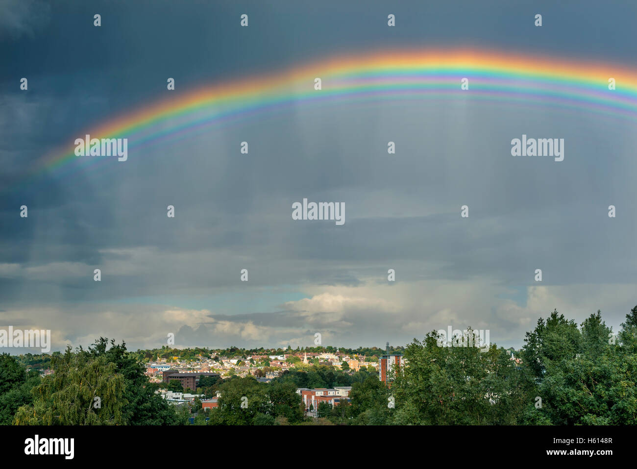 Rare and bizarre multiple rainbow over an English town Stock Photo