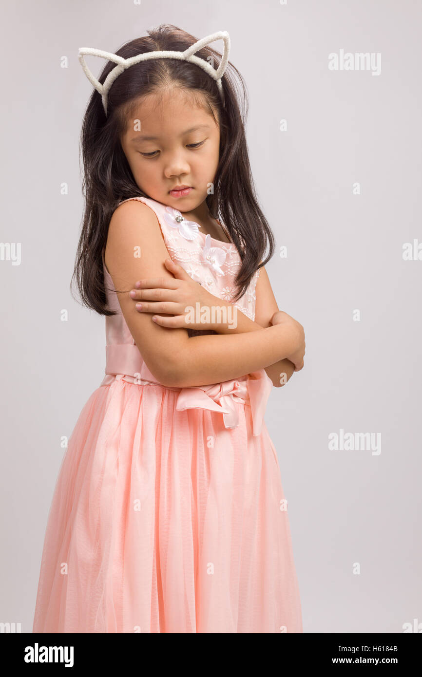 Child with cat ear headband, isolated on white background Stock Photo