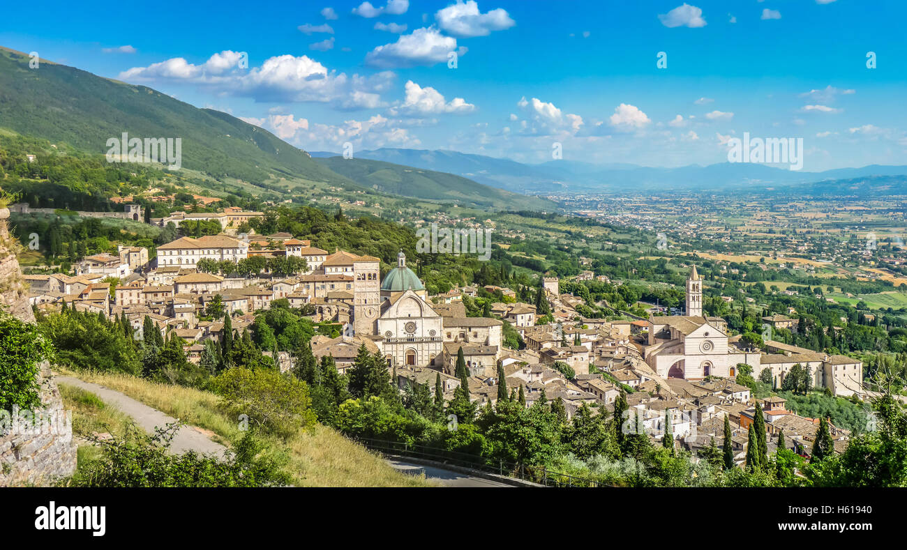 Classic view of the historic town of Assisi ion a sunny day with blue sky and clouds in summer, Umbria, Italy Stock Photo