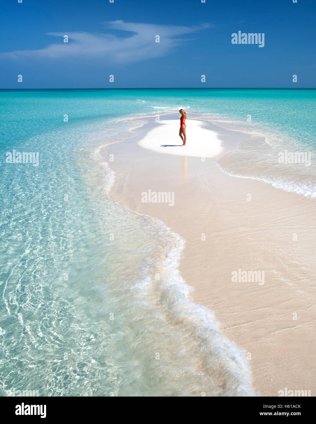 Woman on small sand island. Turks and Caicos. Providenciales Stock Photo