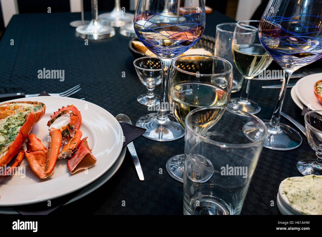 December 31, 2014. A lobster dinner on new years eve with wine glasses  set up on a black table Stock Photo