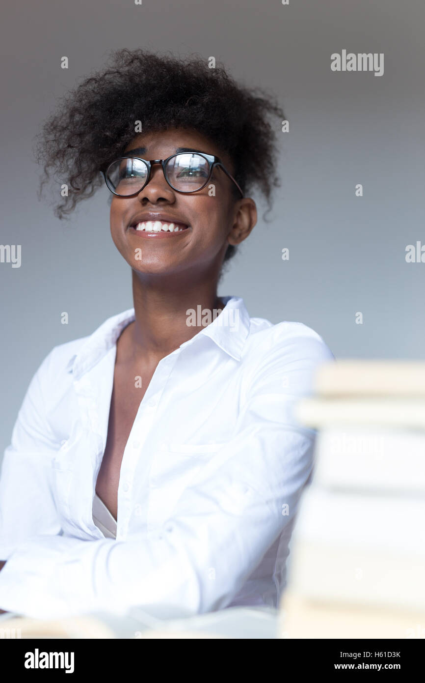 Close up portrait of young black woman laughing against white ...