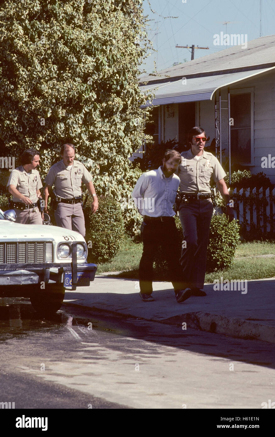 Photojournalist being arrested in San Diego neighborhood after PSA plane crash in 1978. Stock Photo