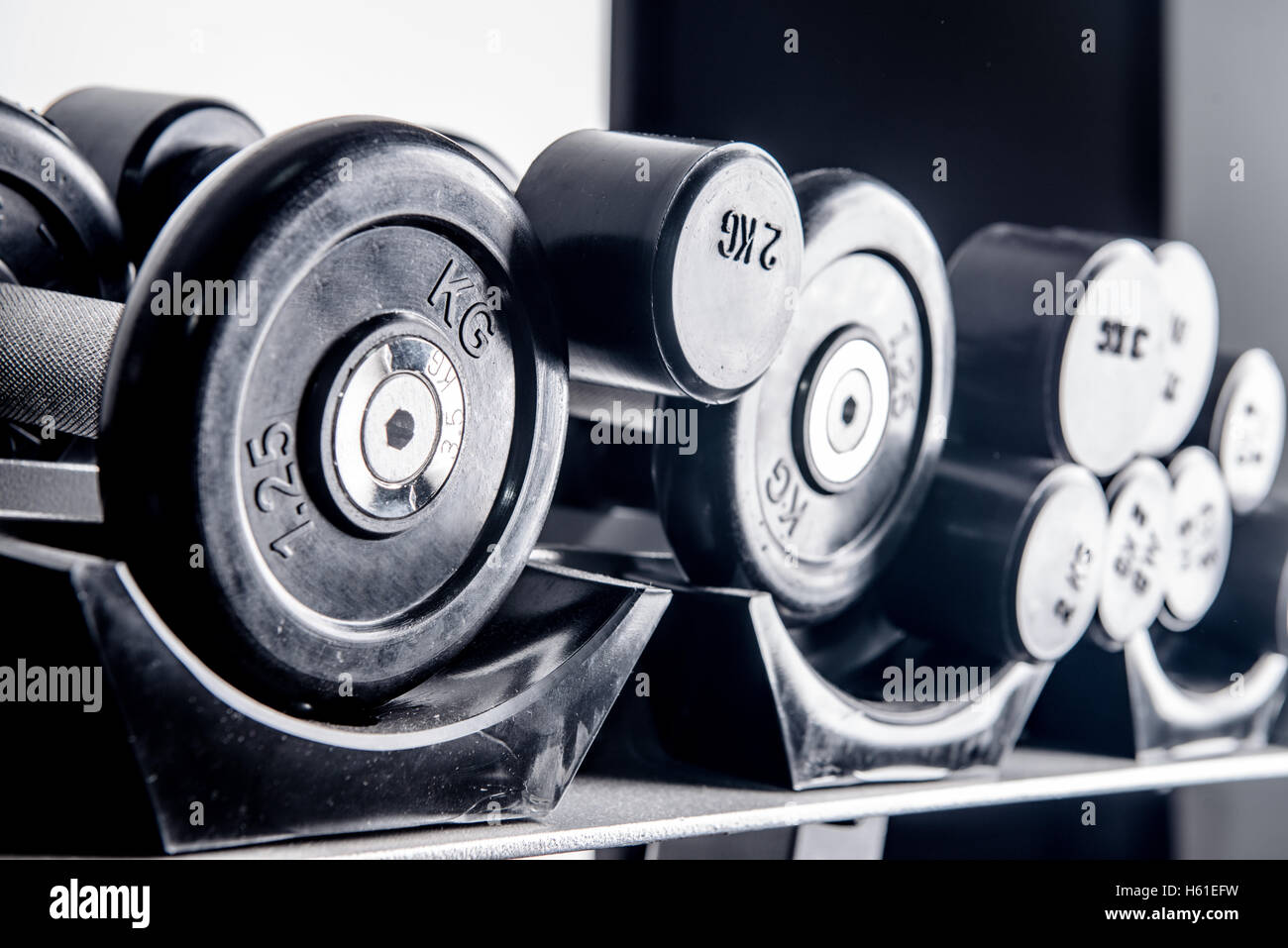 Sports dumbbells in modern sports club. Weight Training Equipment Stock Photo