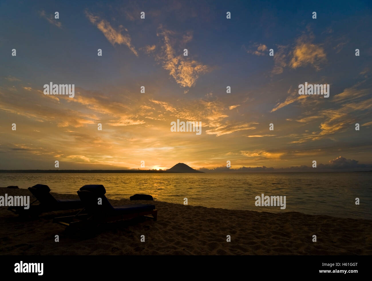 Sunbeds in front of sunset, Siladen island, Sulawesi, Indonesia, Southeast Asia Stock Photo