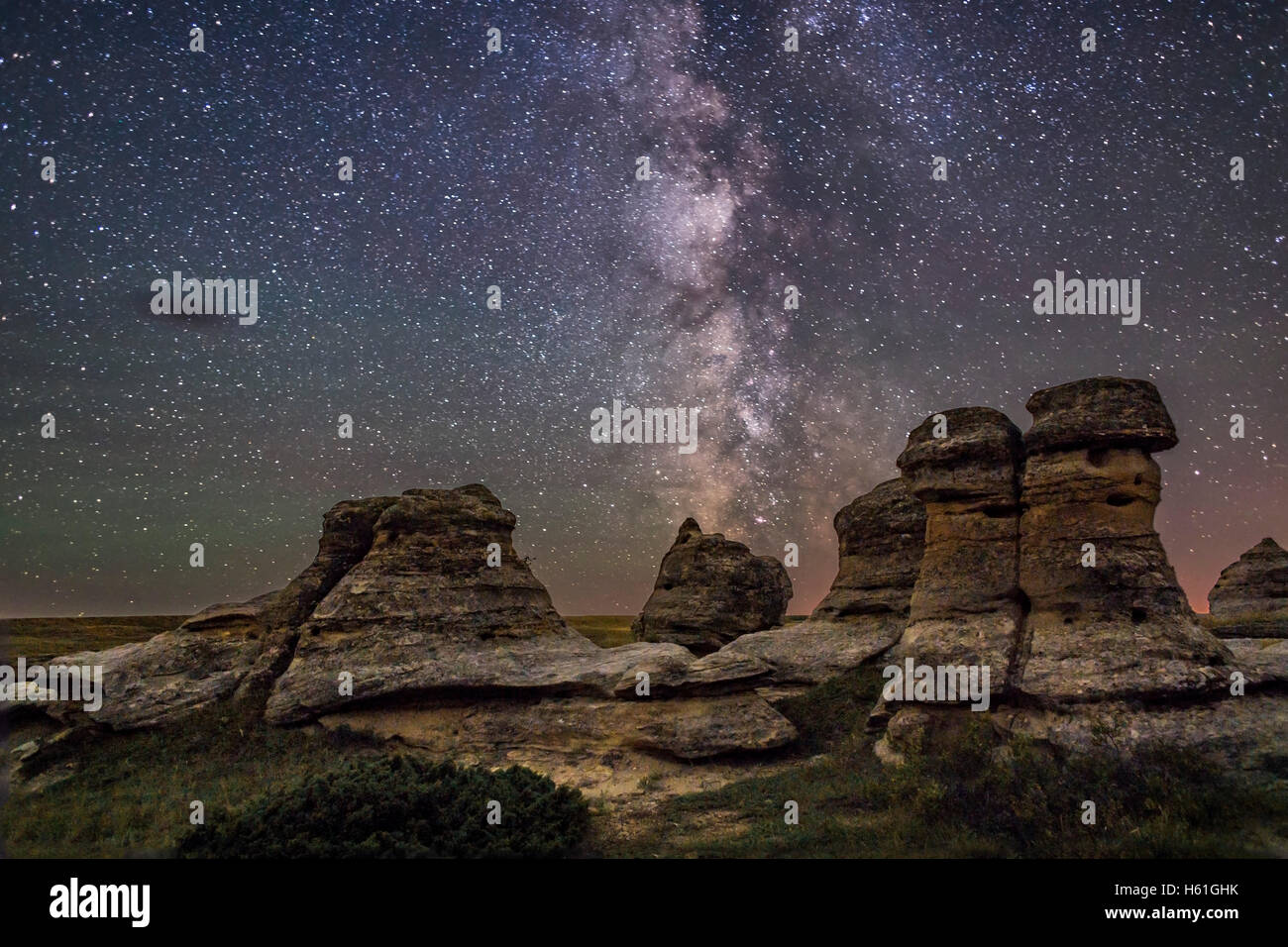 The Milky Way over the sandstone hoodoos of Writing-on-Stone Provincial Park in southern Alberta.   This is a comppsite of a sin Stock Photo