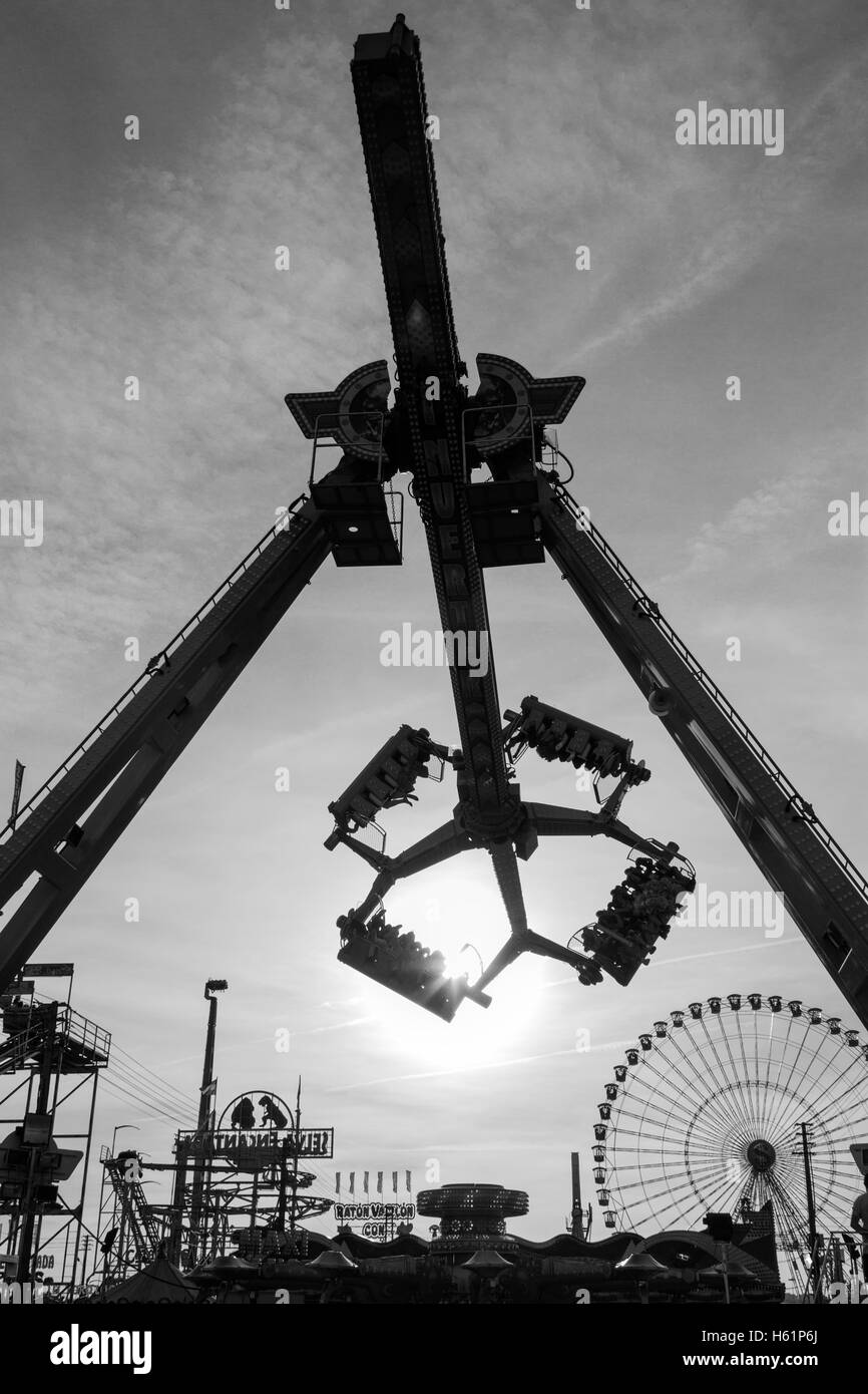 Rides and attractions in a funfair in the evening Stock Photo