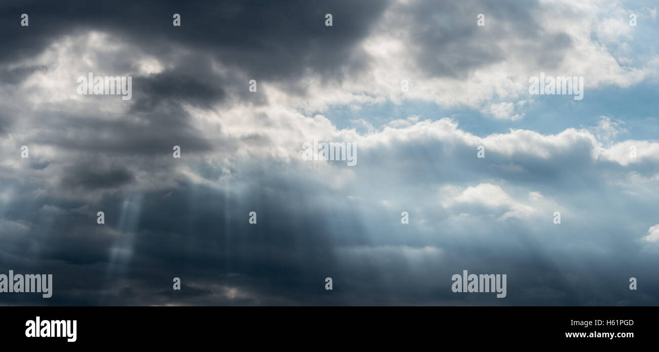 Sunbeams coming out from threatening thunderstorm cloud, France Stock Photo