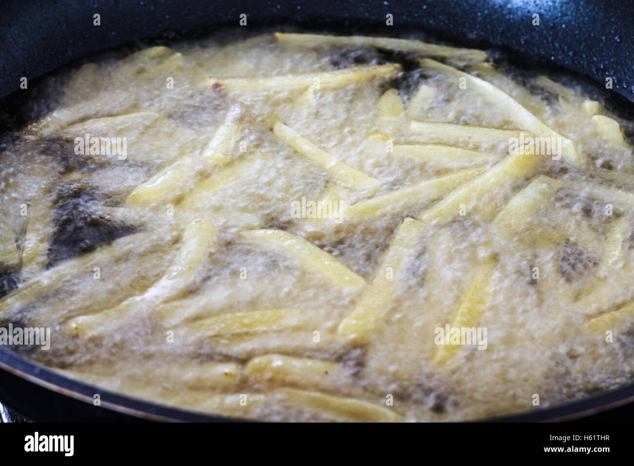 Chips, potatoes frying in the pan in olive oil Stock Photo Alamy