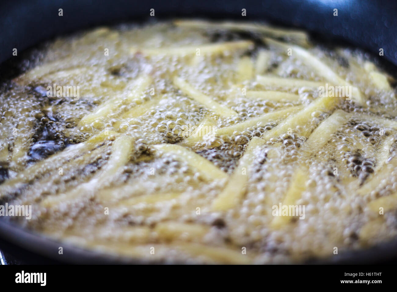 Chips, potatoes frying in the pan in olive oil Stock Photo Alamy