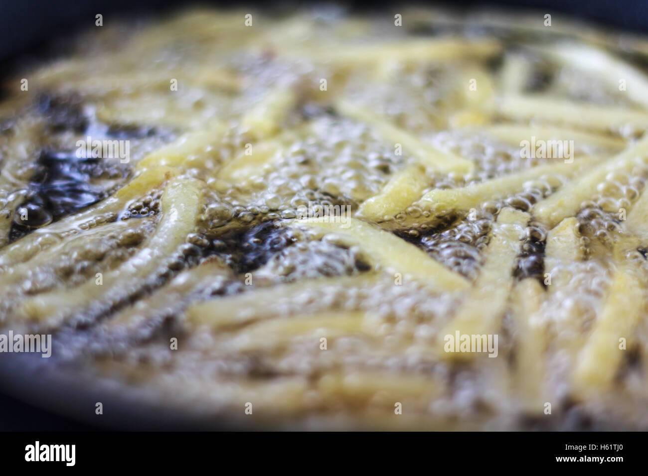 Chips, potatoes frying in the pan in olive oil Stock Photo Alamy