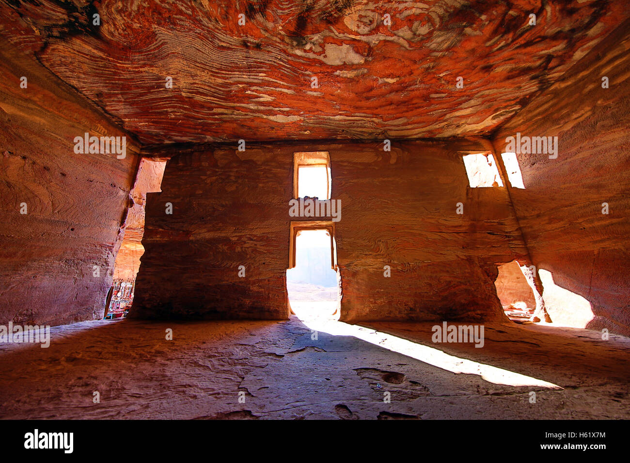 Light streaming through the windows of the Urn Tomb of the Royal Tombs in the rock city of Petra, Jordan Stock Photo