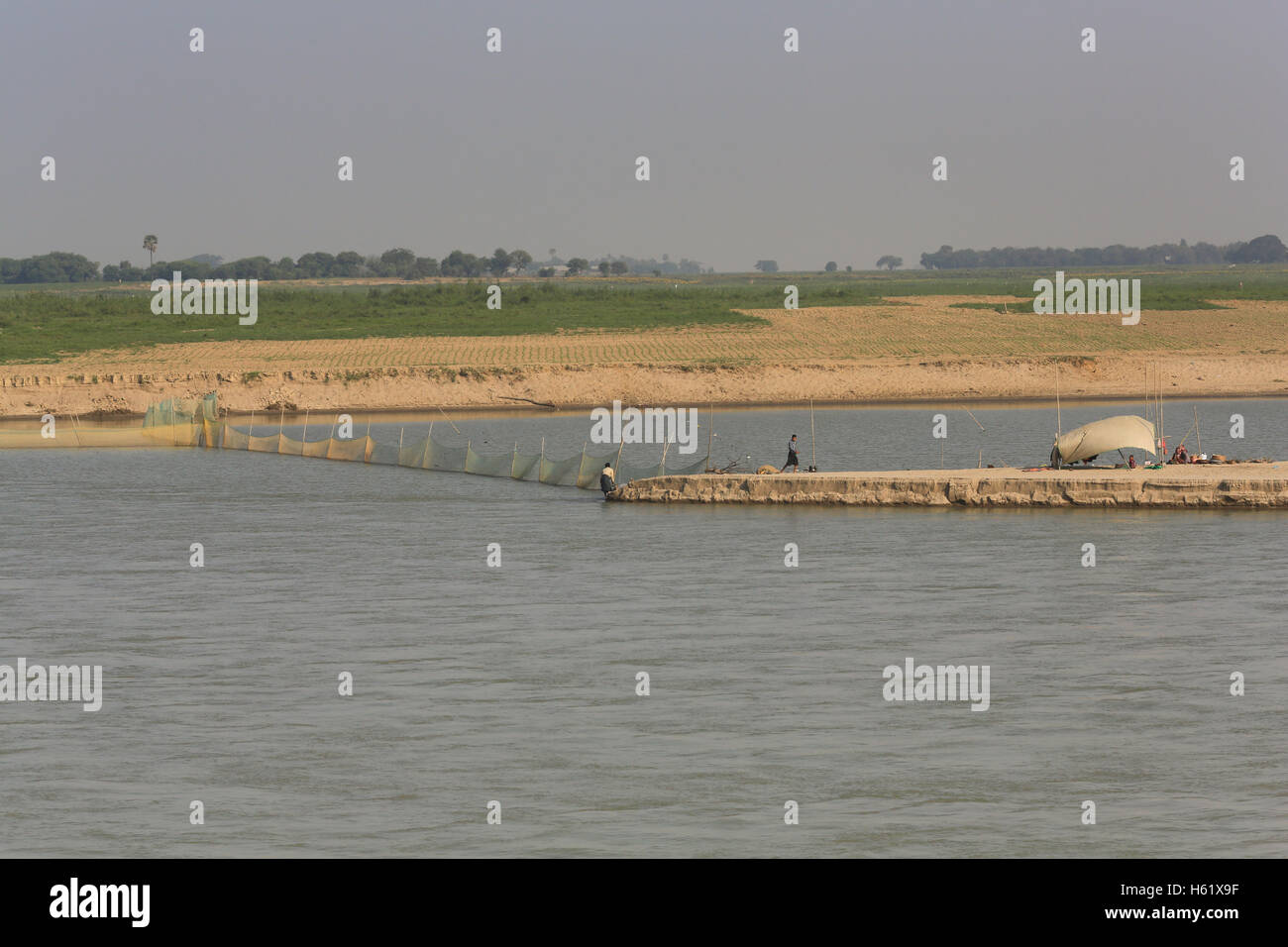 Fishermen use nets to trap fish on the Irrawaddy River in Myanmar. Stock Photo