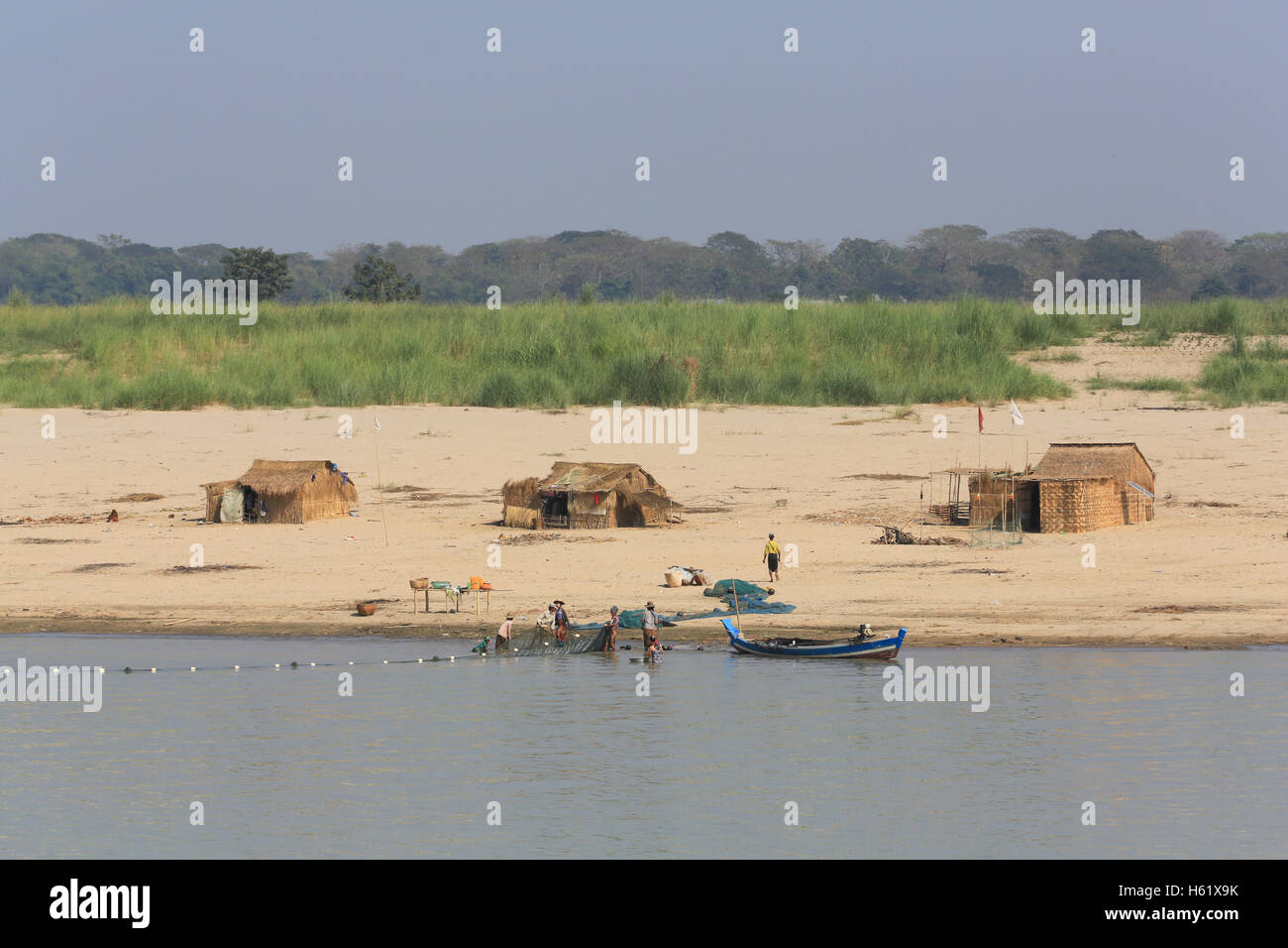 An old wooden fishing boat with nets floats on the ocean with