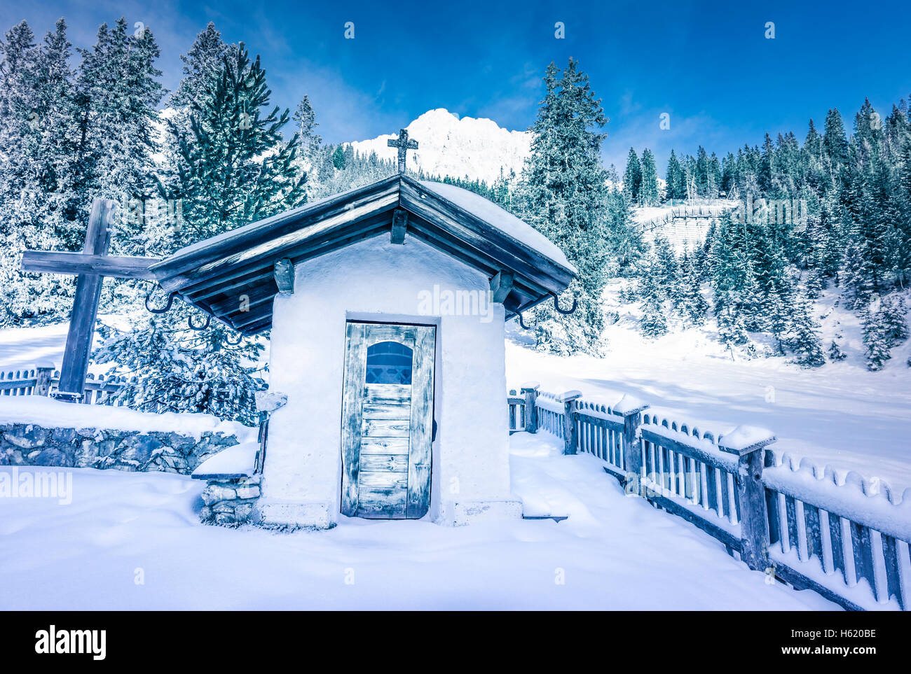 Alpine rustic chapel in winter decor Stock Photo
