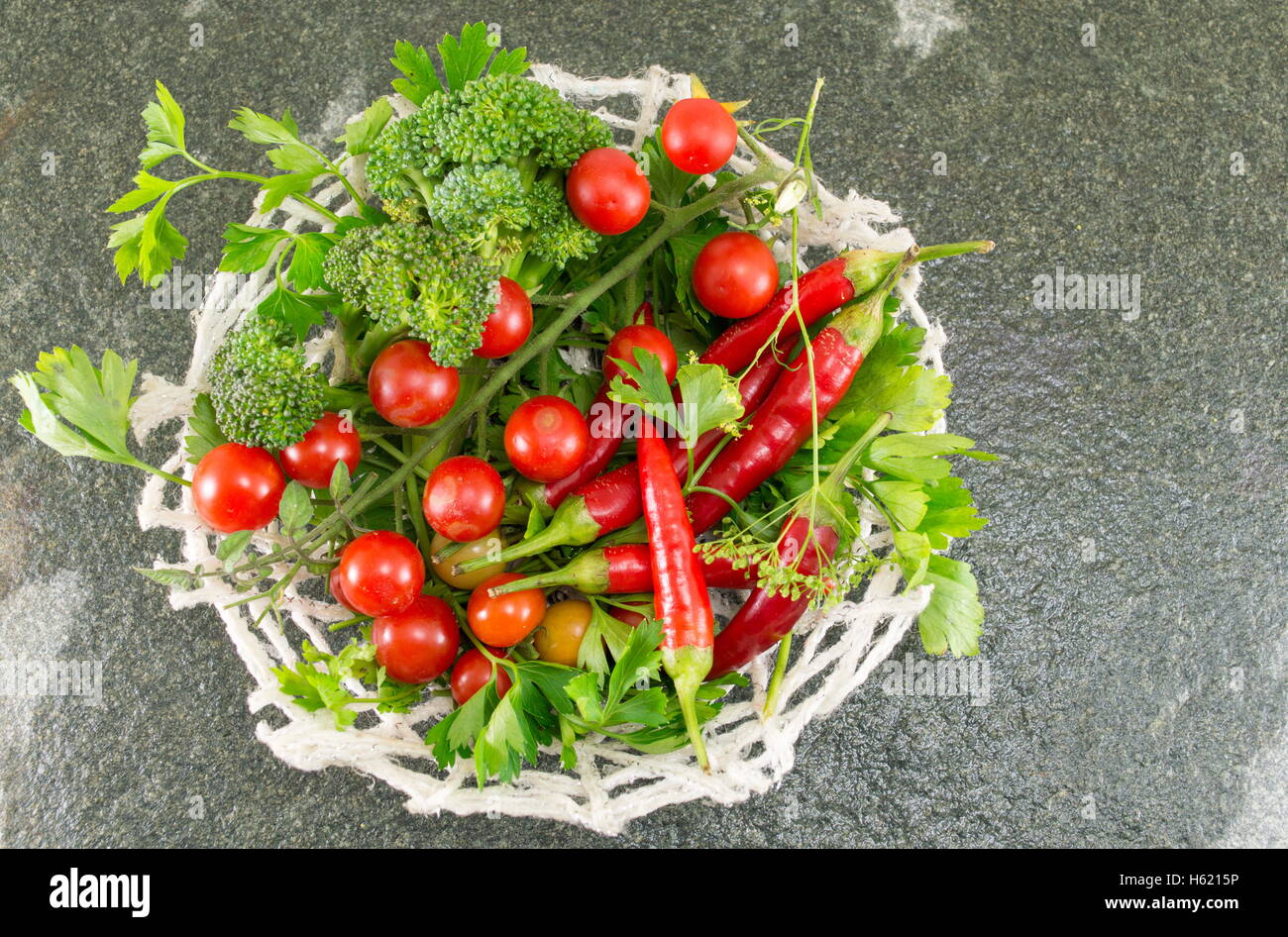 Raw tomato and red pepper on stone background Stock Photo