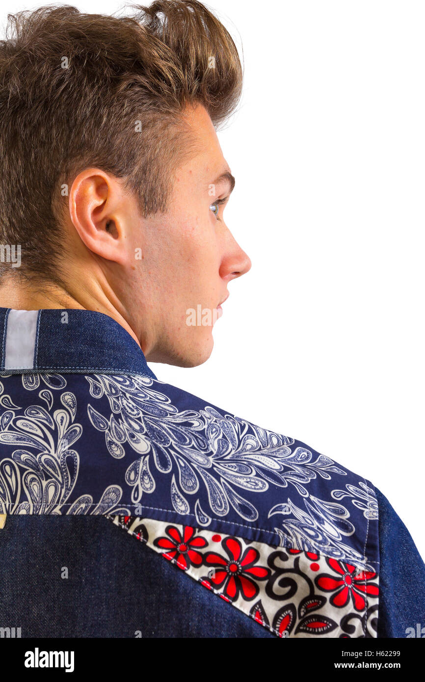 Young blond stylish man in blue denim shirt with floral pattern detail, product catalog catalogue shot, looking over shoulder Stock Photo