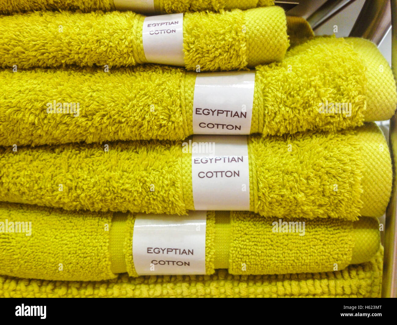 Towels, mats, robes and other home bath wear on shelves made of Egyptian Cotton Stock Photo