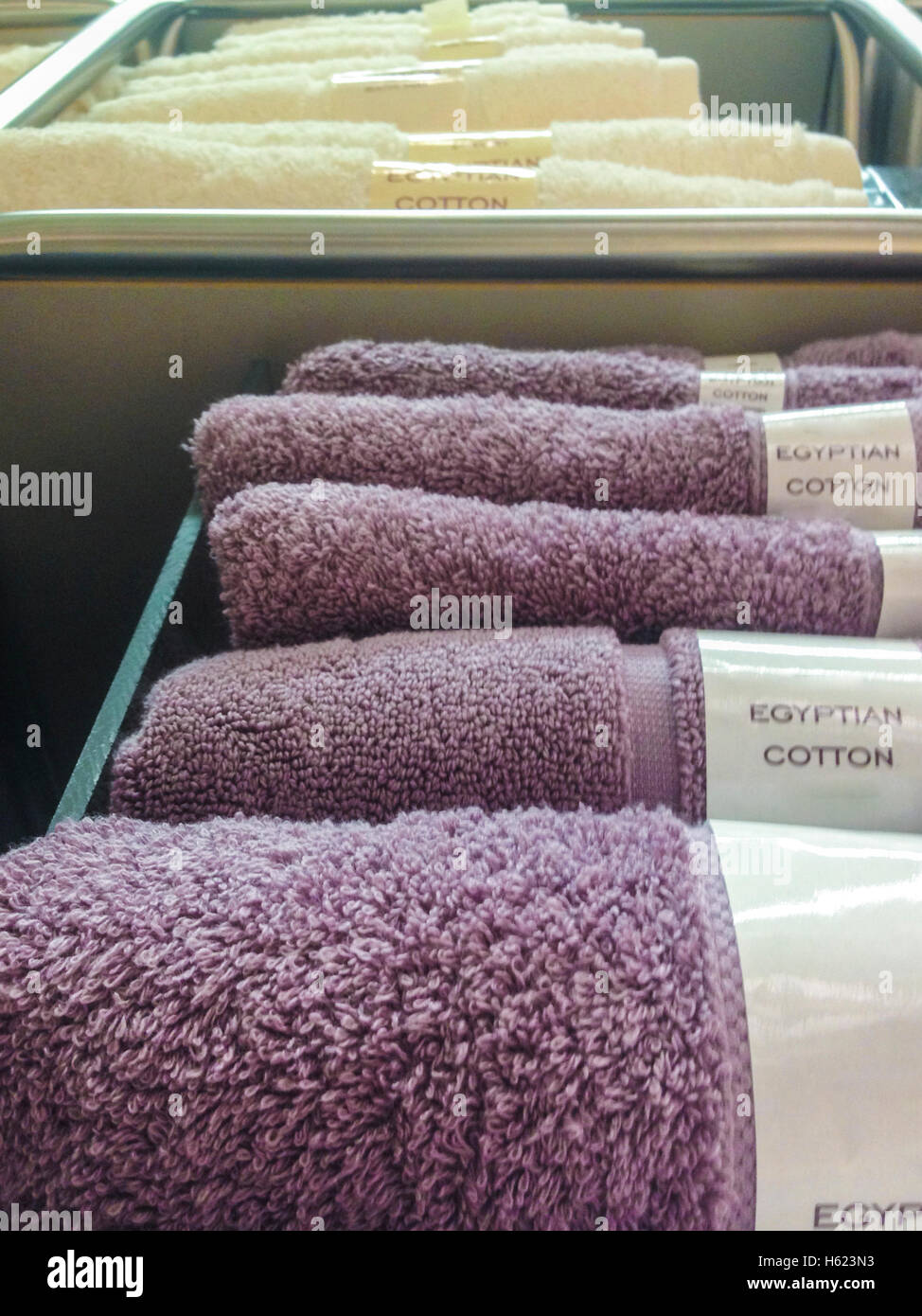 Towels, mats, robes and other home bath wear on shelves made of Egyptian Cotton Stock Photo