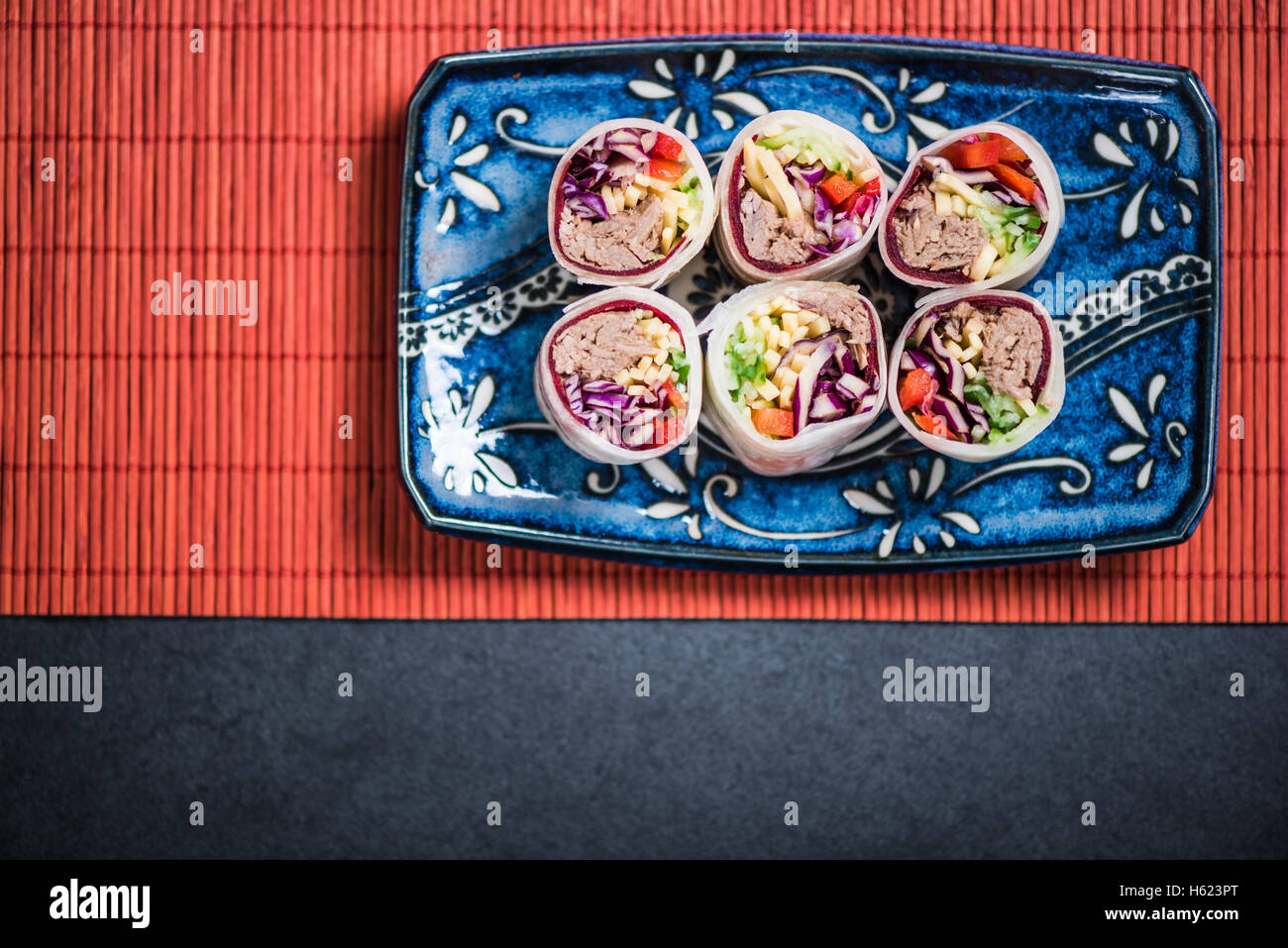 Sushi bites overhead view on bamboo mat Stock Photo