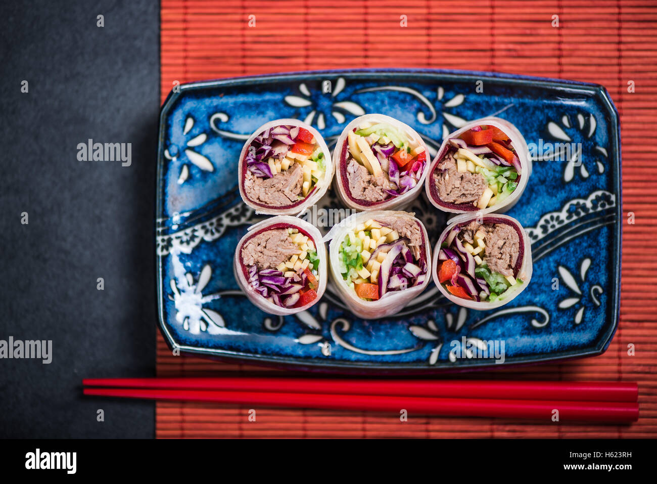 Japanese sushi top view on dark slate and red bamboo mat Stock Photo