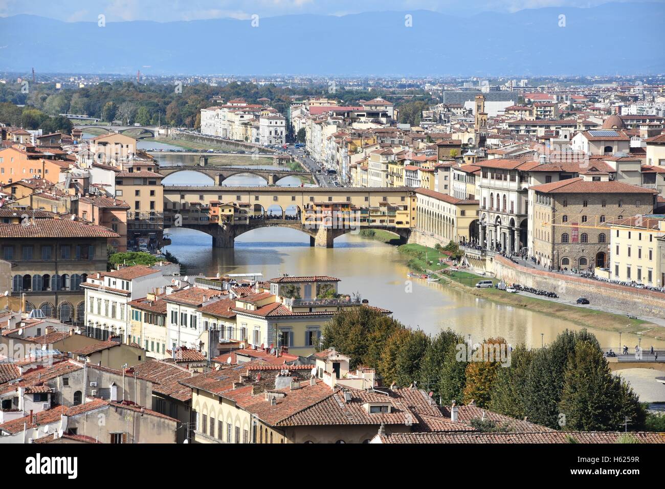 The Arno river of Florence with the Ponte Vecchio, a side view of the Uffizi Gallery and a part of the Vasari Corridor Stock Photo