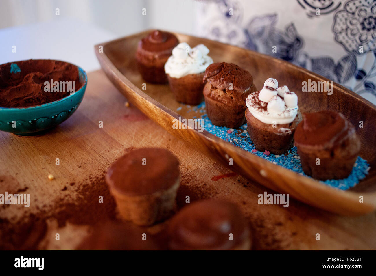 cooking cupcakes, muffins and a plate of ingredients for decoration on the table Stock Photo