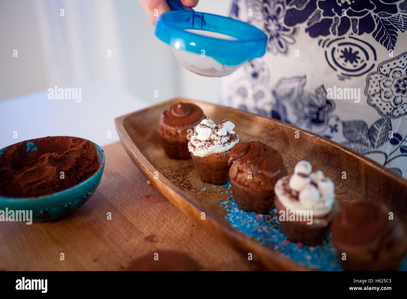 cooking cupcakes, muffins and a plate of ingredients for decoration on the table Stock Photo
