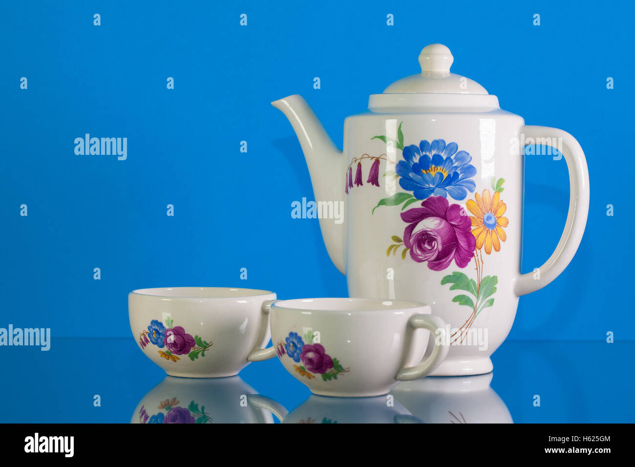 Very old porcelain tea set on blue reflection background Stock Photo ...