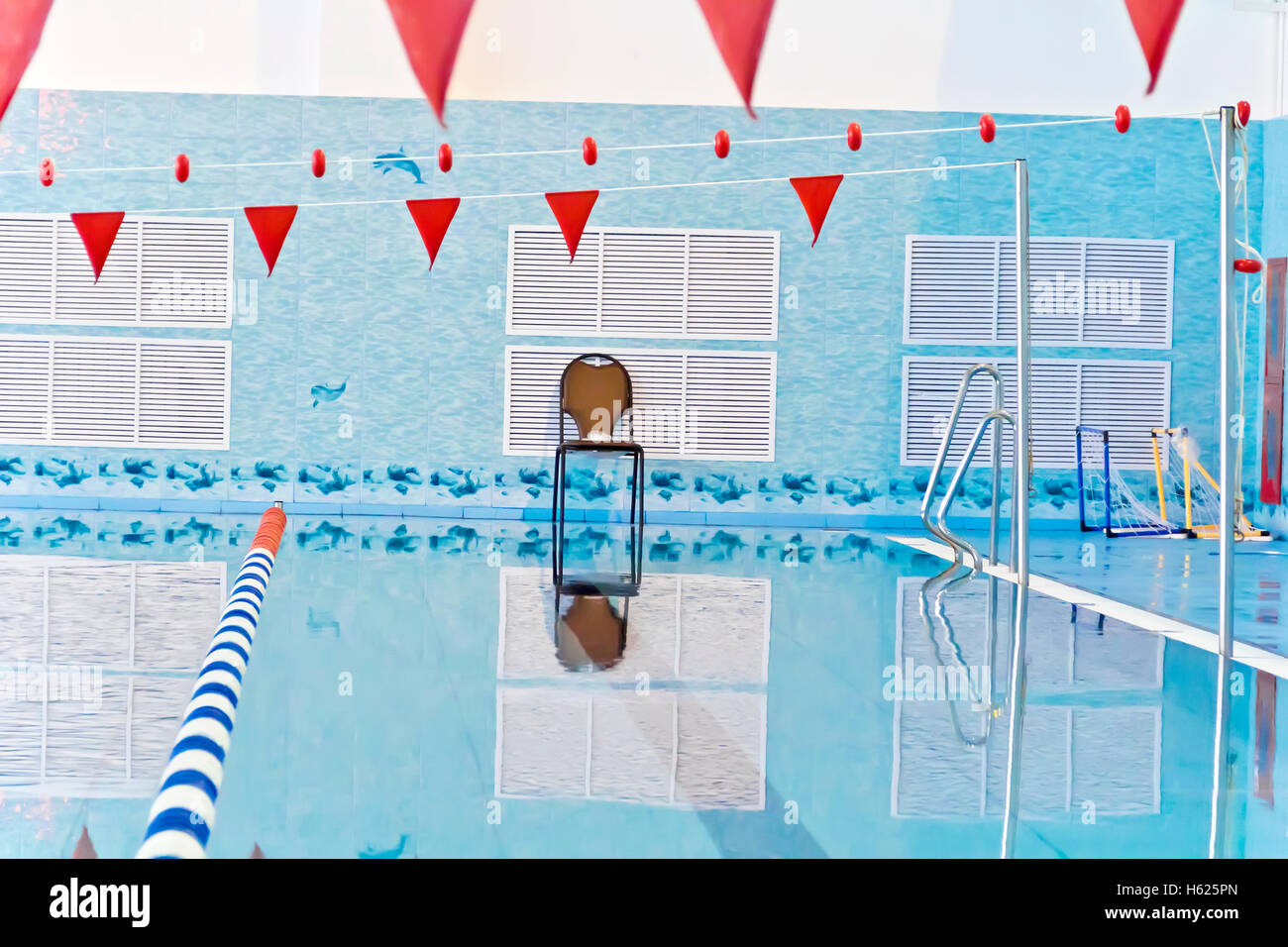 Photo of empty swimming pool with red flags Stock Photo