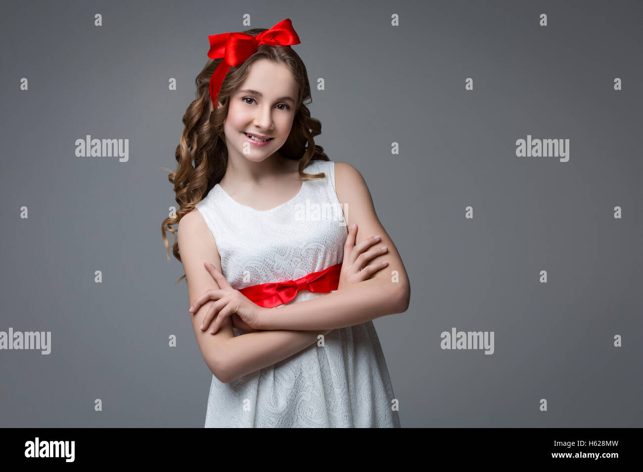 Teen girl with red bow on head Stock Photo