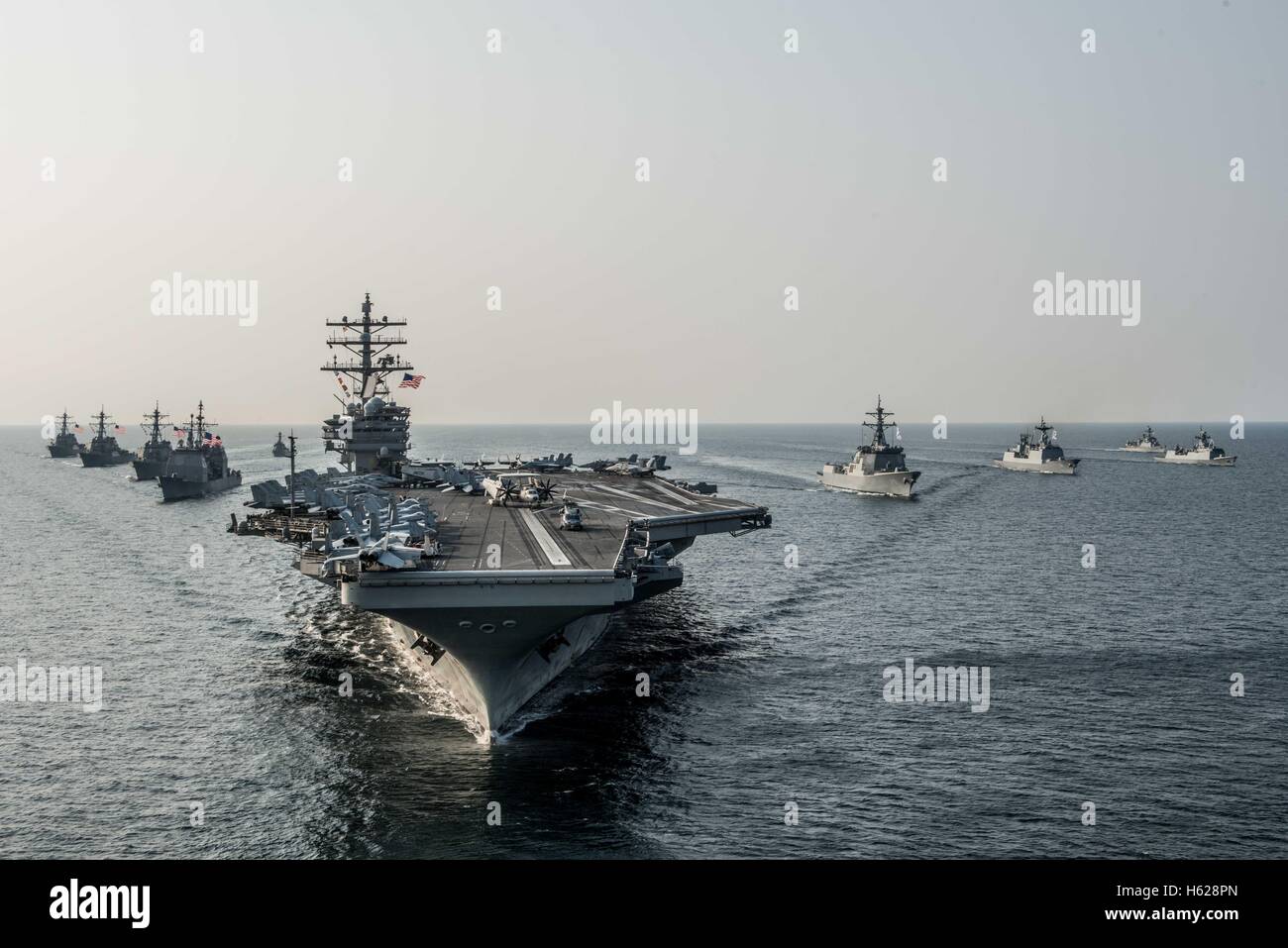 The US Navy Nimitz-class nuclear-powered aircraft carrier USS Ronald Reagan steams in formation with other ships during Exercise Invincible Spirit October 14, 2016 off the coast of the Korean Peninsula. Stock Photo