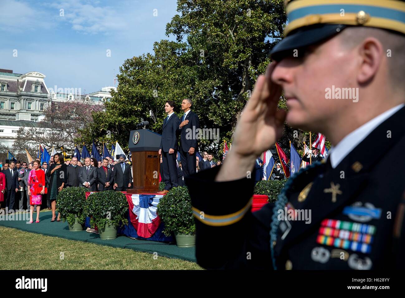 U.S. President Barack Obama and Canadian Prime Minister Justin Trudeau stand during the U.S. national anthem at the Canada State Arrival ceremony on the White House South Lawn March 10, 2016 in Washington, DC. Stock Photo