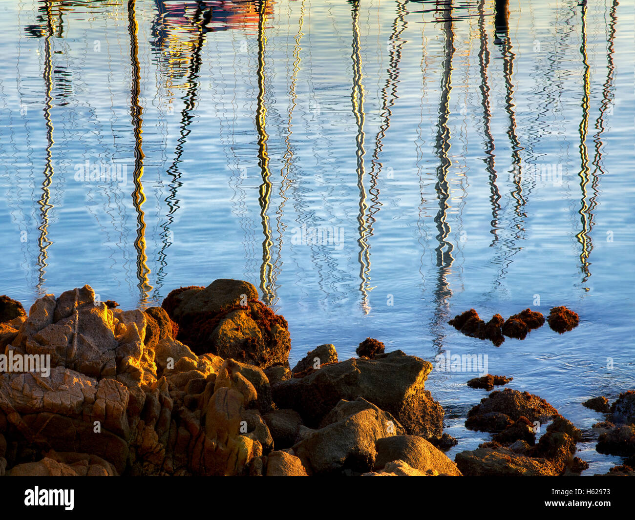 Reflected sailing masts at Monterey Harbor and Marina, California Stock Photo