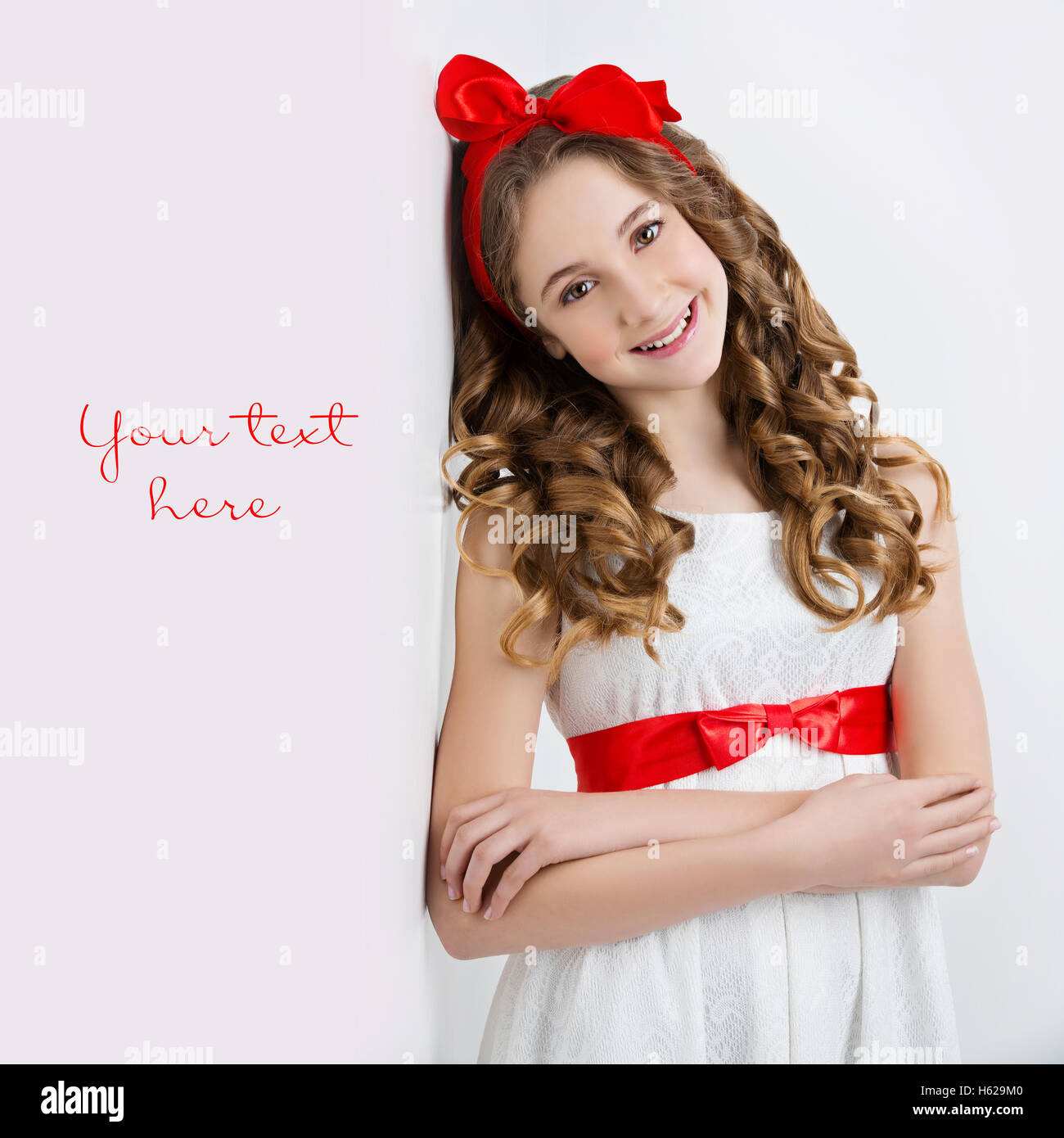 Teen girl with red bow on head Stock Photo