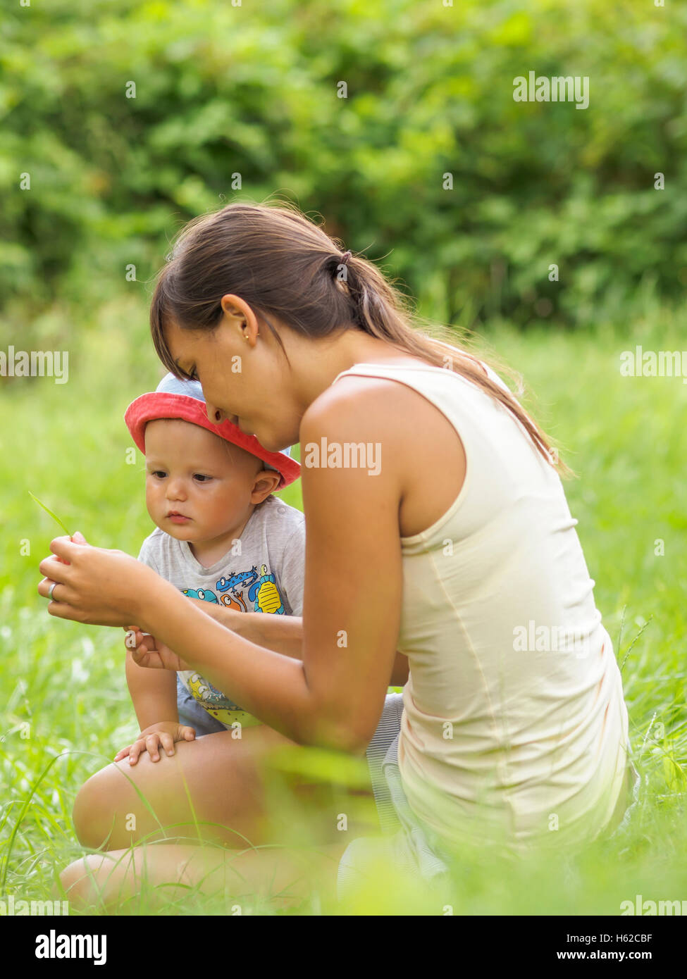 Mother and baby boy together on a meadow Stock Photo